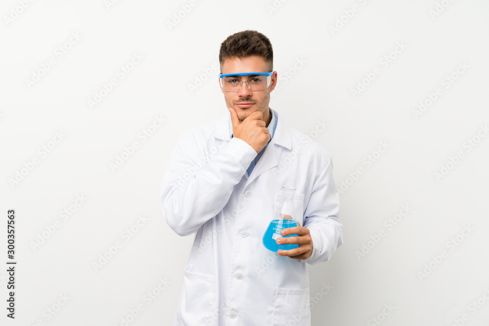 Young scientific holding laboratory flask over isolated background laughing Young scientific holding laboratory flask over isolated background laughing