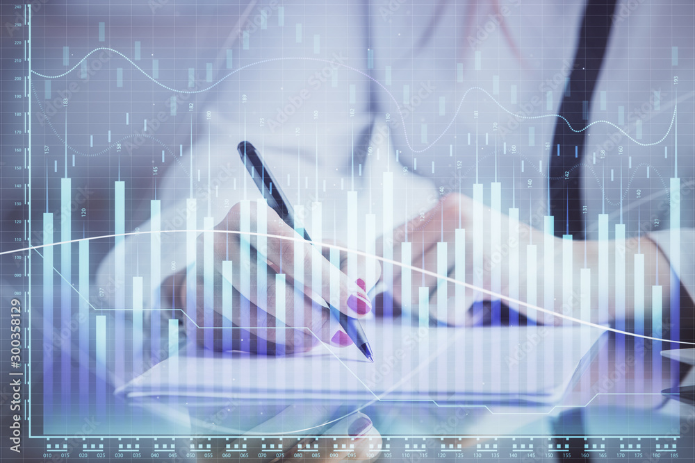 Double exposure of hands making notes with forex chart huds. Stock market concept. Double exposure of hands making notes with forex chart huds. Stock market concept.