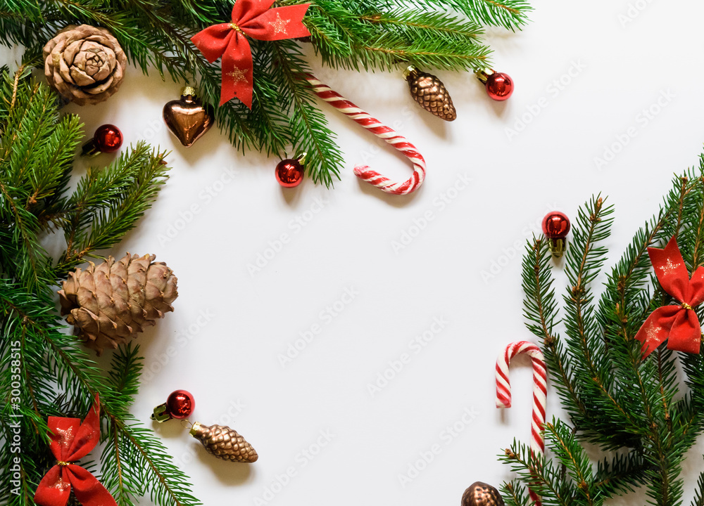 top view, green branches of spruce together with New Year's toys and bows on a white background top view, green branches of spruce together with New Year's toys and bows on a white background