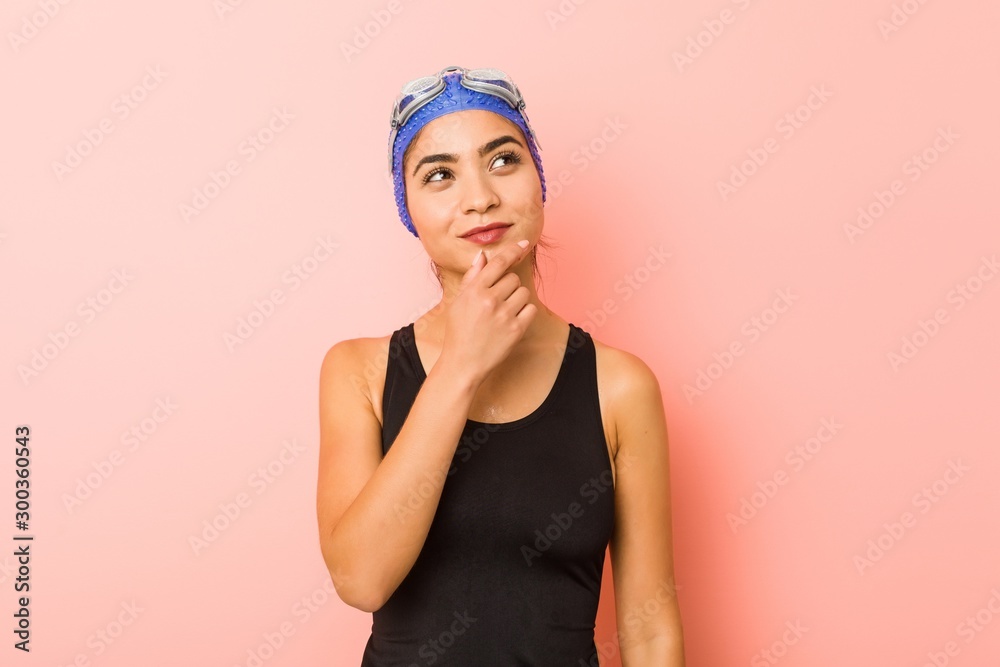Young arab swimmer woman isolated looking sideways with doubtful and skeptical expression. Young arab swimmer woman isolated looking sideways with doubtful and skeptical expression.