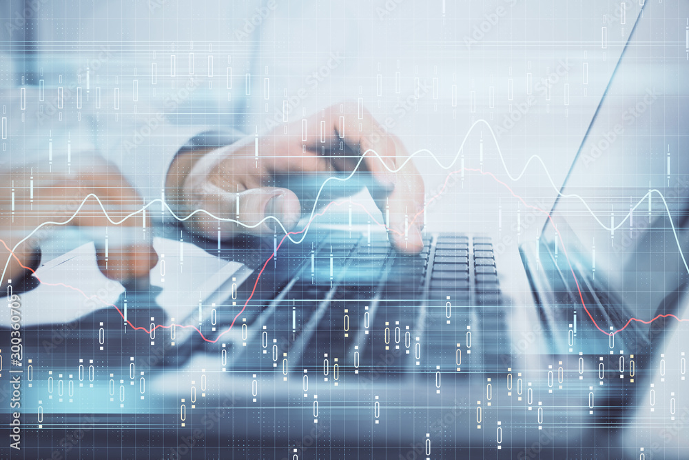 Double exposure of market chart with man working on computer on background. Concept of financial analysis.