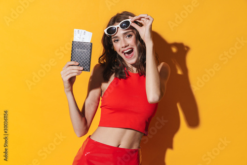 Attractive young cheerful woman showing passport