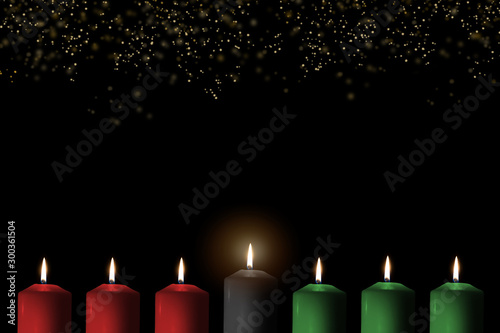Kwanzaa for African-American cultural holiday celebration with candle light of seven candle sticks in black, green, red symbolising 7 principles of African Heritage (Nguzo Saba) photo