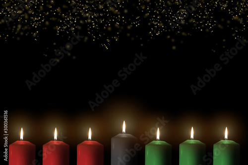 Kwanzaa for African-American cultural holiday celebration with candle light of seven candle sticks in black, green, red symbolising 7 principles of African Heritage (Nguzo Saba)