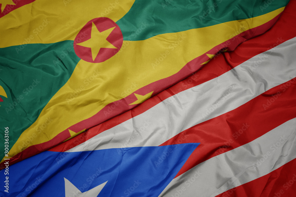waving colorful flag of puerto rico and national flag of grenada.