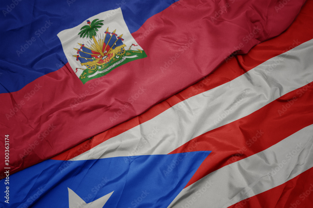 Fototapeta premium waving colorful flag of puerto rico and national flag of haiti.