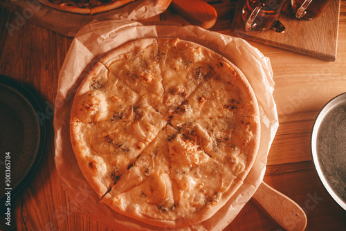delicious fresh homemade pizza on the table. pizza with pear and green blue cheese