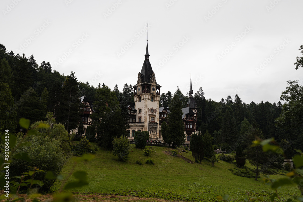 Famous Castle Peles in Sinaia as shot during a rainy day with moody sky and rolling fog (Sinaia, Romania, Europe) Famous Castle Peles in Sinaia as shot during a rainy day with moody sky and rolling fog (Sinaia, Romania, Europe)