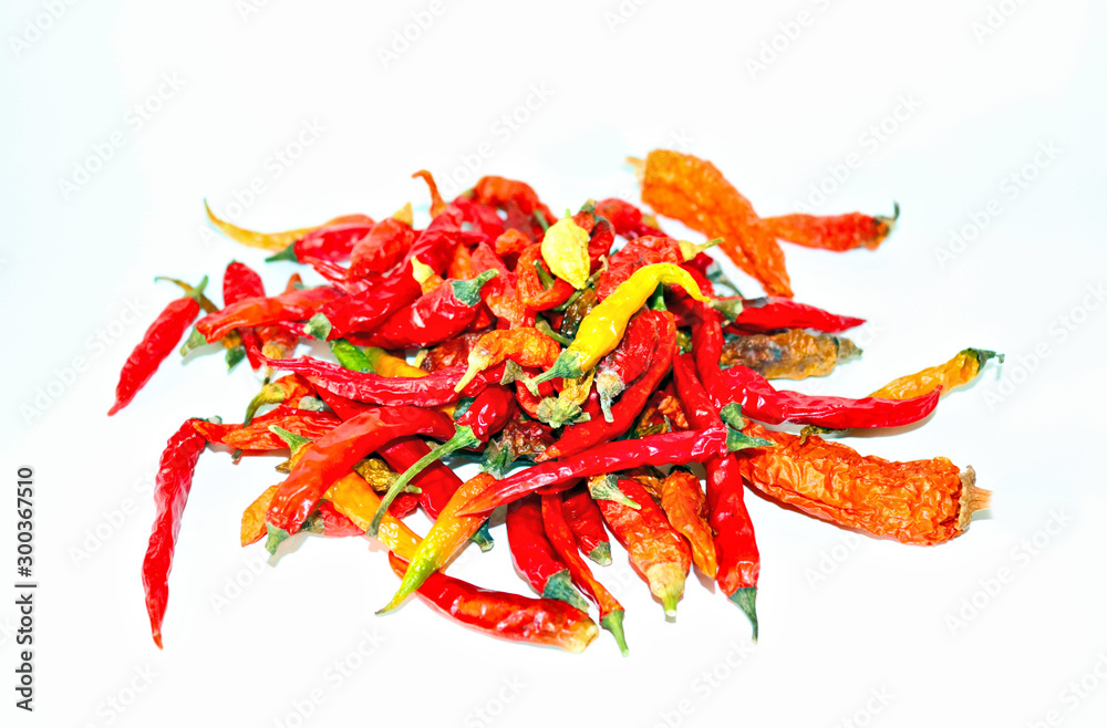 dried hot chili peppers, yellow and green pods on a light background dried hot chili peppers, yellow and green pods on a light background