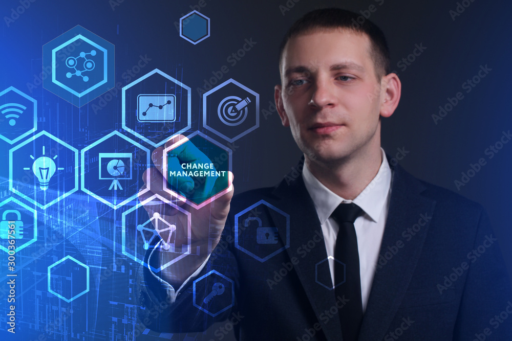 Business, Technology, Internet and network concept. Young businessman working on a virtual screen of the future and sees the inscription: Change management Business, Technology, Internet and network concept. Young businessman working on a virtual screen of the future and sees the inscription: Change management