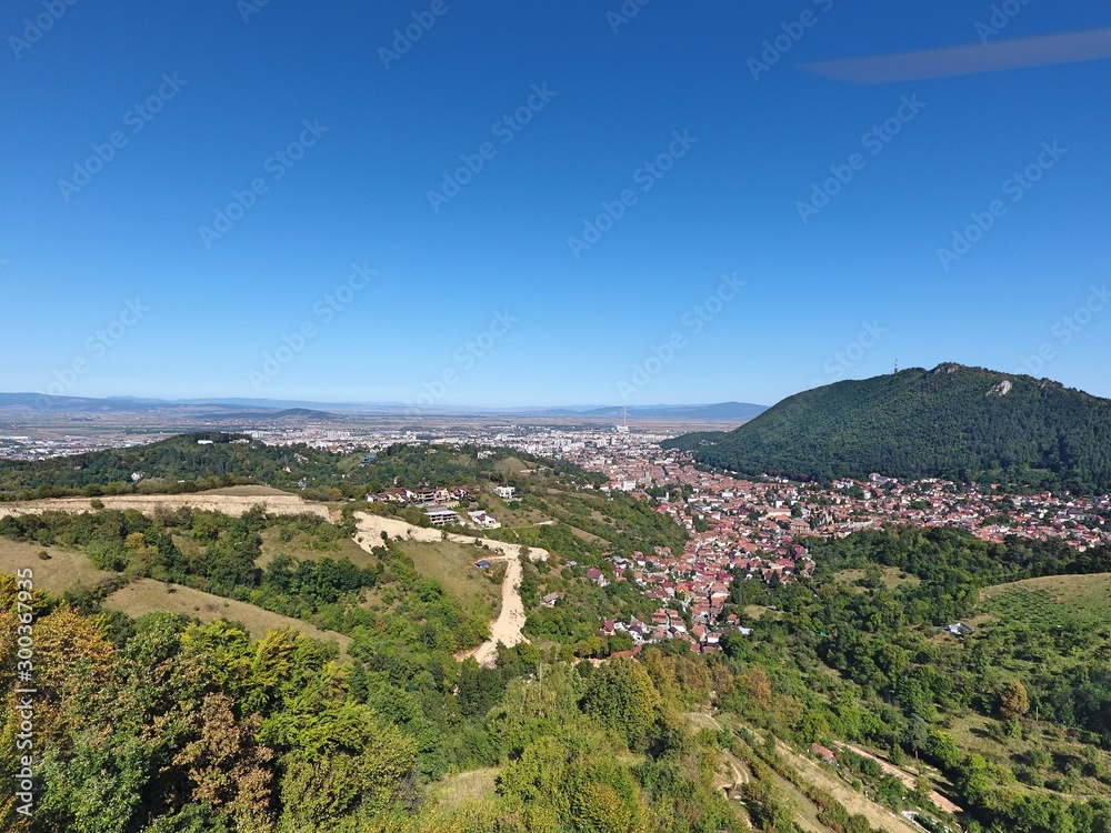 Fototapeta premium On the top of the city. Drone footage. Romanian mountains.