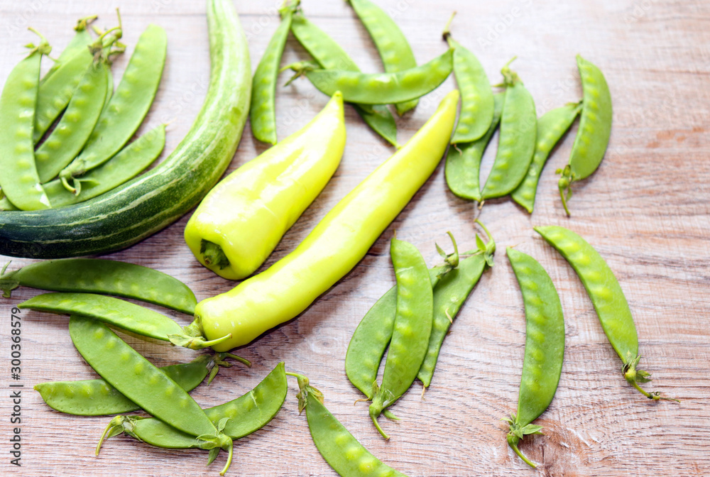 fresh green vegetables on a light background, peas, peppers, cabbage fresh green vegetables on a light background, peas, peppers, cabbage