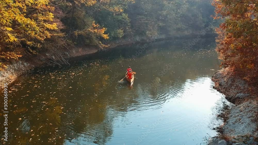 Two men canoeist paddling canoe, tracking shot Two men canoeist paddling canoe, tracking shot