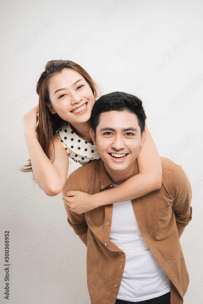 man carrying his lover on back, woman showing peace symbol over white background man carrying his lover on back, woman showing peace symbol over white background