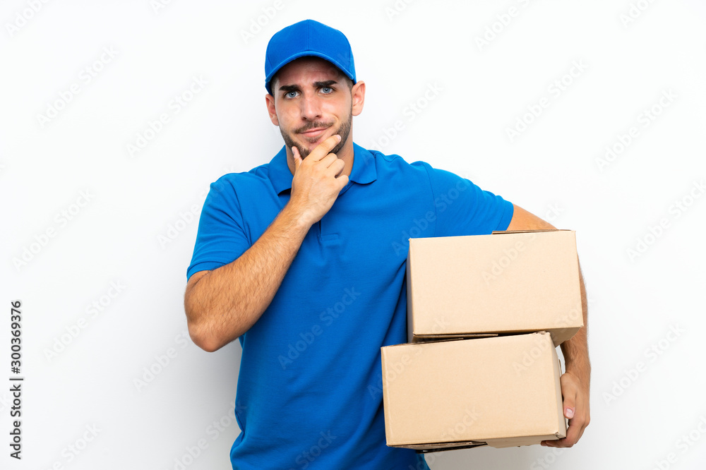 Delivery man over isolated white background laughing Delivery man over isolated white background laughing