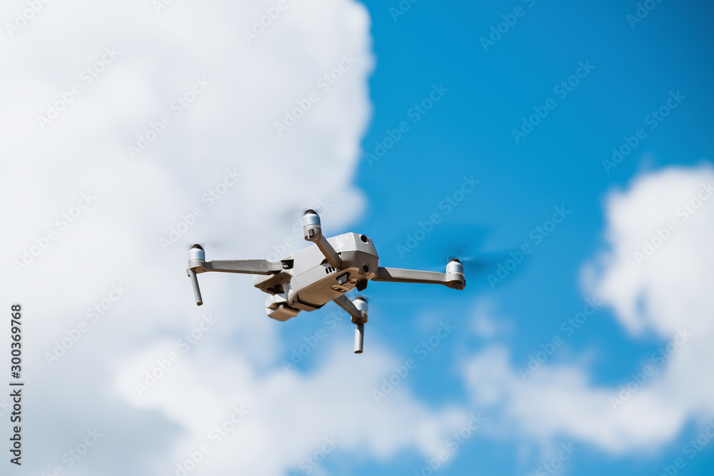 Gray drone flies against the sky with clouds Gray drone flies against the sky with clouds