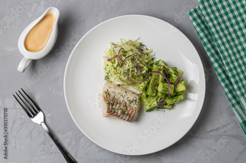 Boiled cod salad with cucumber, cabbage and red onion. Dish for people with diabetes and overweight. The view from the top. Copy space. photo