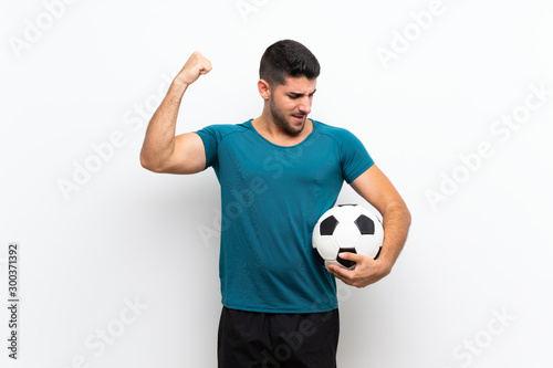 Handsome young football player man over isolated white wall celebrating a victory © luismolinero