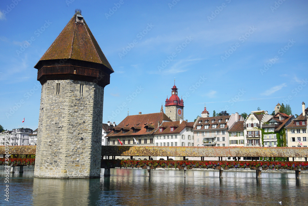 Iconic view of Lucerne chapel bridge and ancient water tower, world-famous travel destination in Switzerland.