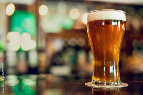 Close-up of beer glass served on table in the beer bar photo