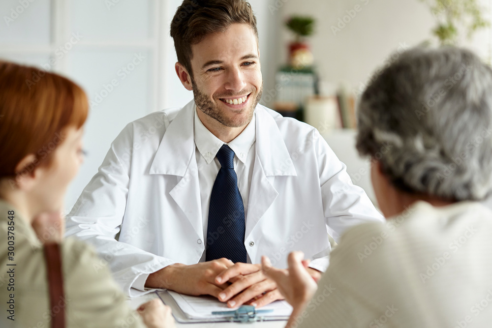 Senior patient talking with doctor, her daughter sitting besides her Senior patient talking with doctor, her daughter sitting besides her