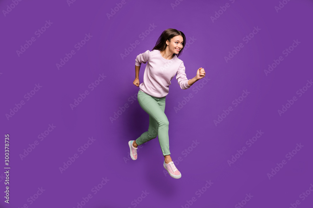 Full length body size view of her she nice attractive charming lovely winsome slim fit thin cheerful girl jumping running isolated over bright vivid shine vibrant purple violet lilac color background