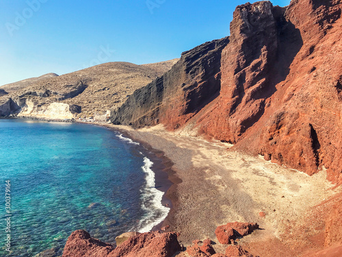 Red volcanic beach in Santorini, Greece. Azure water of the Mediterranean Sea.