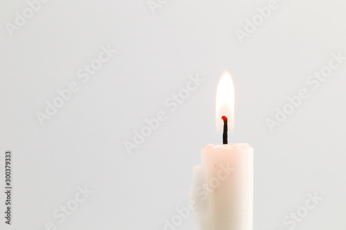 white candle flame on black background