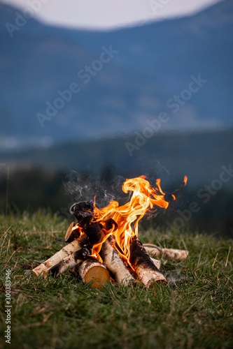 Fotografie, Obraz Burning bonfire in the evening in the Carpathian mountains