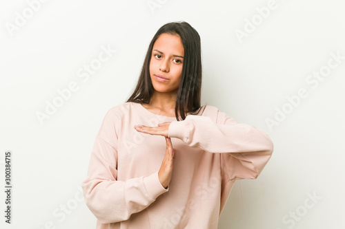 Young cute hispanic teenager woman showing a timeout gesture. © Asier