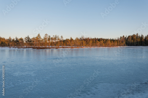 A frozen lake in the forests of Pirkanmaa, Finland in winter