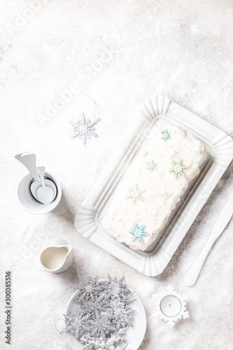 Christmas Fruit Cake  Pudding on snowy background . New Year pastries