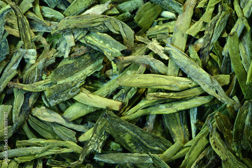 Loose leaf green tea in close up. Longjing tea, Dragon Well tea, origin of China. Expensive, very high quality Chinese green tea, a speciality.