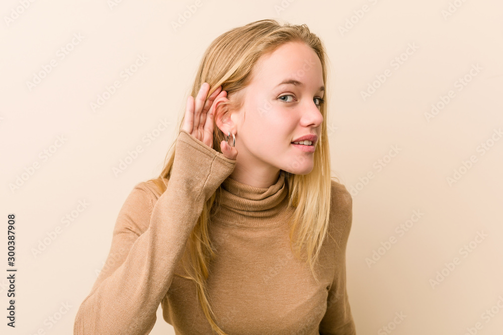 Fototapeta premium Cute and natural teenager woman trying to listening a gossip.