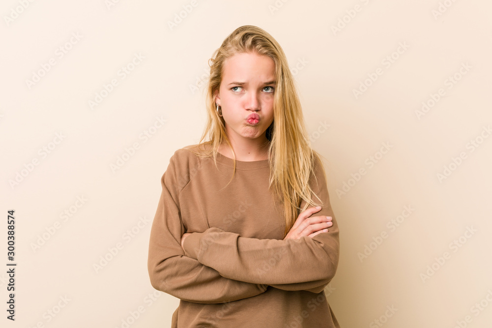 Cute and natural teenager woman blows cheeks, has tired expression. Facial expression concept. Cute and natural teenager woman blows cheeks, has tired expression. Facial expression concept.