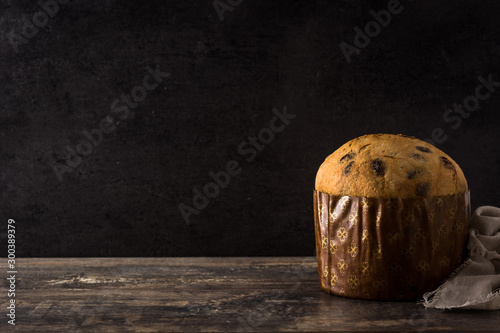 Christmas chocolate panettone cake on wooden table. Copy space