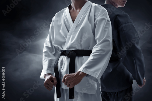 Two karate martial arts fighter on dark background photo