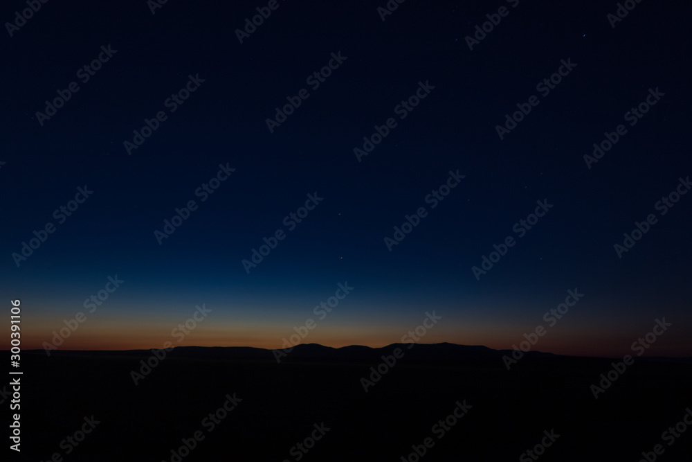 Sunset landscape view of silhouette mountains