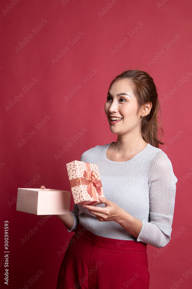 Young Asian woman open a gift box. Young Asian woman open a gift box.