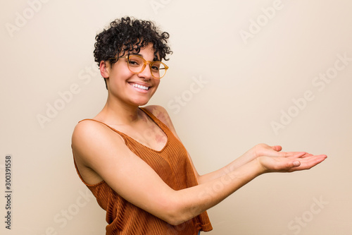 Young african american woman with skin birth mark holding a copy space on a palm.