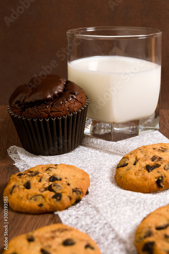 A glass of milk. Chocolate Chip Cookies. Tasty and pleasant Christmas dessert. Chocolate cake