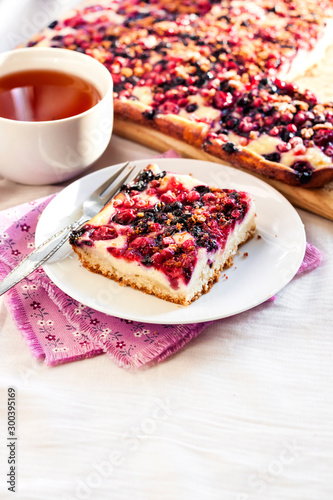 Tasty breakfast. Delicious pie with berries and cottage cheese an a cup of tea
