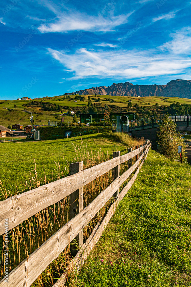 Beautiful alpine view with a wooden fence at the famous Seiser Alm, South Tyrol, Italy