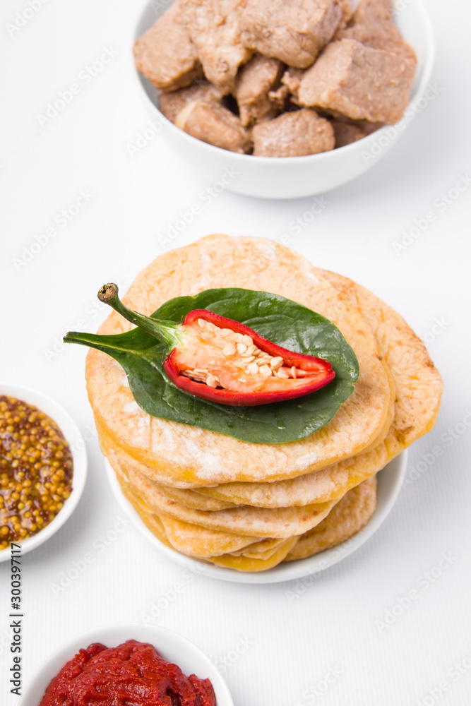 cornmeal tortillas on a white plate nearby. Mexican cuisine. cornmeal tortillas on a white plate nearby. Mexican cuisine.