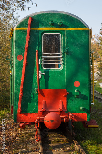 Children's railway. Green train with wagons on the platform