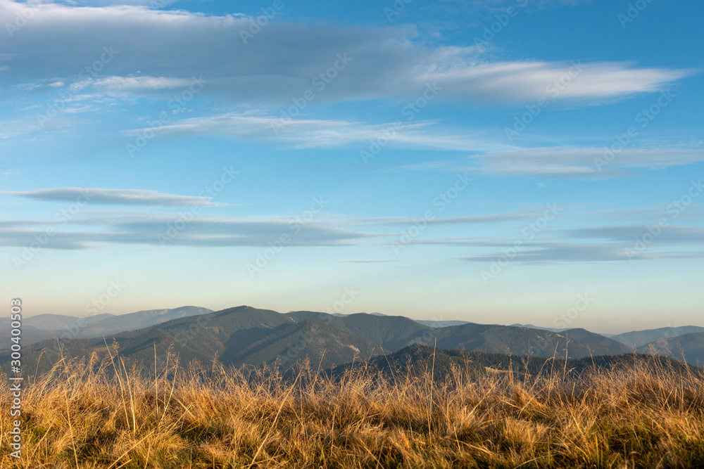 Fototapeta premium Beautiful sunset and layered mountain silhouettes in evening