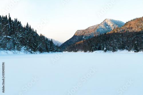 Winter landscape with covered river and mountains, Canada