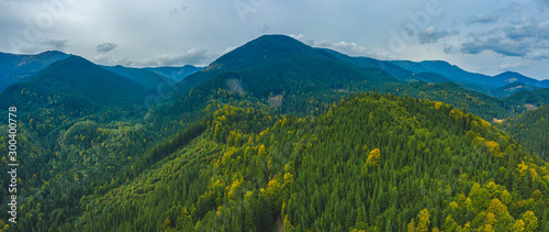 Aerial view amazing over of the Carpathian Mountains or Carpathians with Beautiful autumn landscape, sunrise, blue sky with white clouds, fog between the mountain slopes © ArtSvitlyna