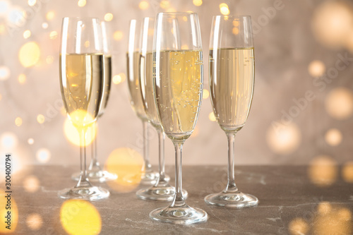 Champagne glasses against blurred lights background. Bokeh effect