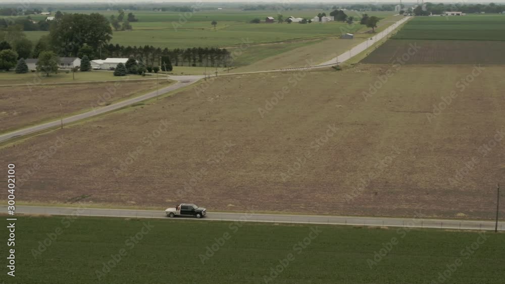 Pan right aerial, truck drives though rural Illinois Pan right aerial, truck drives though rural Illinois
